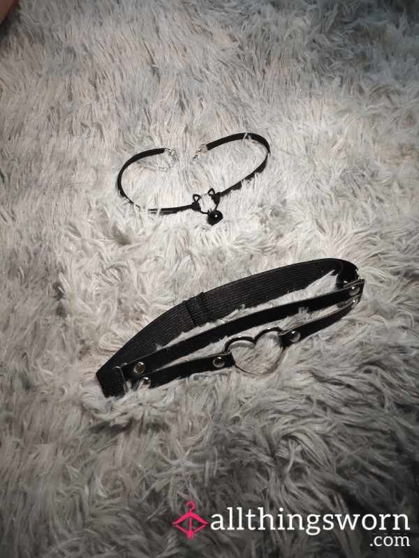 A Black Collar With A Bell And A Thigh Strap