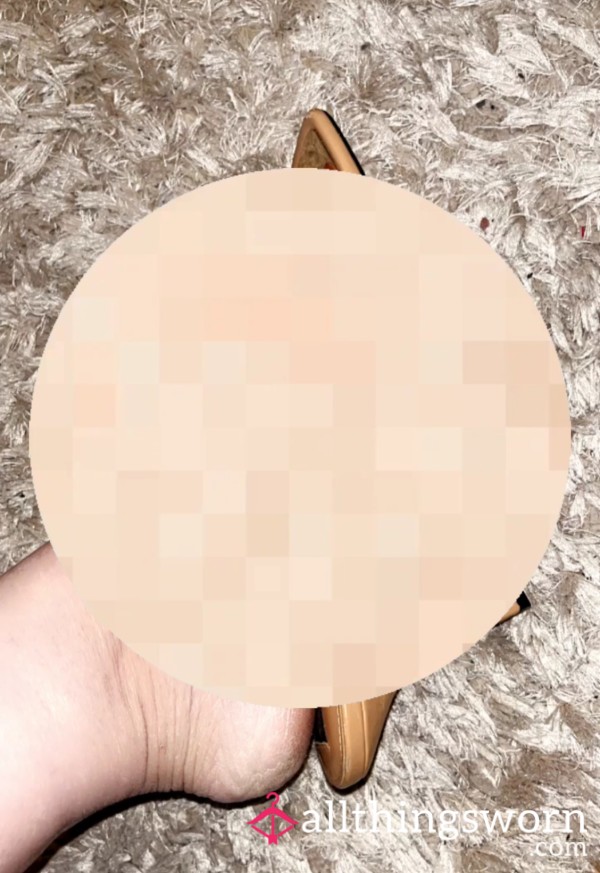 A Graceful South Asian Foot Slipping Effortlessly Into A Woven Nude Backless Heel
