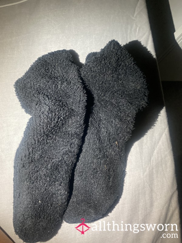 A Pair Of Well Worn Long Black Fluffy Winter Socks
