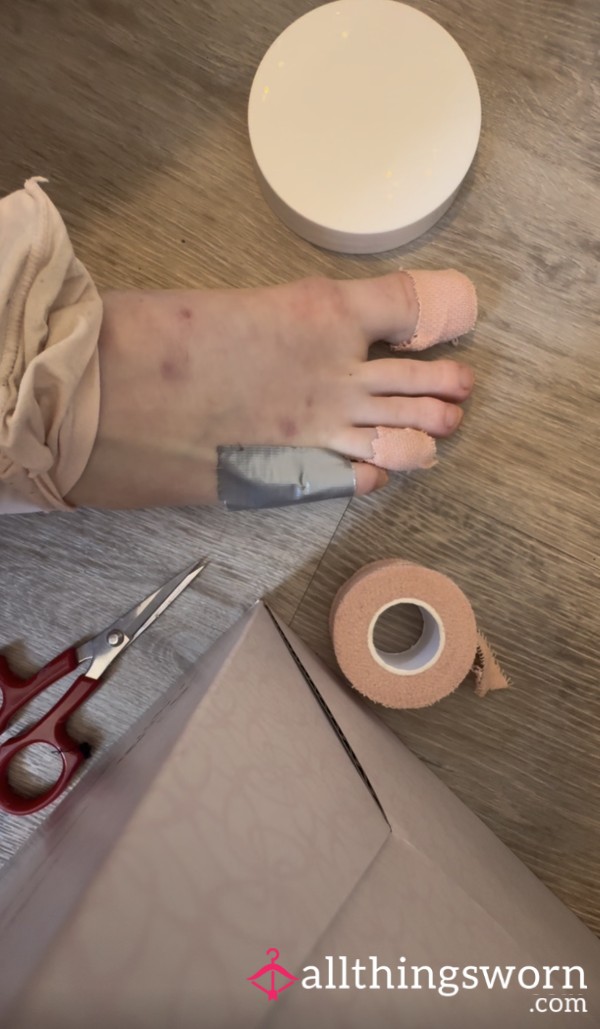 Ballerina Taping Toes And Prepping Feet For Pointe Shoes