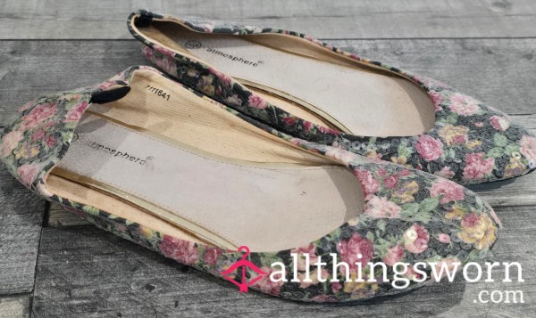 Charming Yet Rather Worn Flat Shoes, Adorned With A Lovely Flor*l Design.