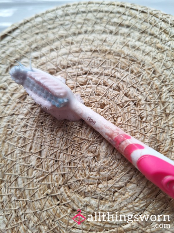 Dirty Worn Toothbrush Complete With Leftover Lipstick