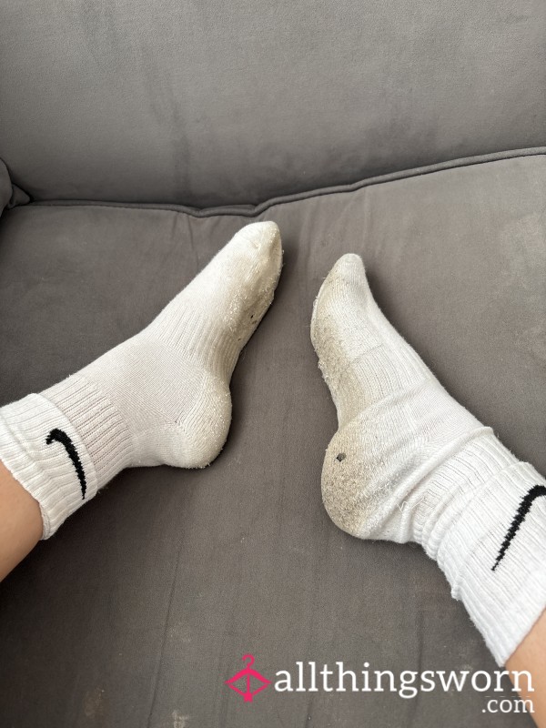 Extremely Dirty And Worn White Nike Socks
