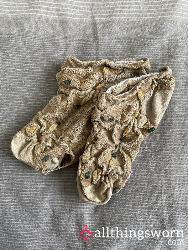 Worn Down Flowery Socks With Holes On Soles