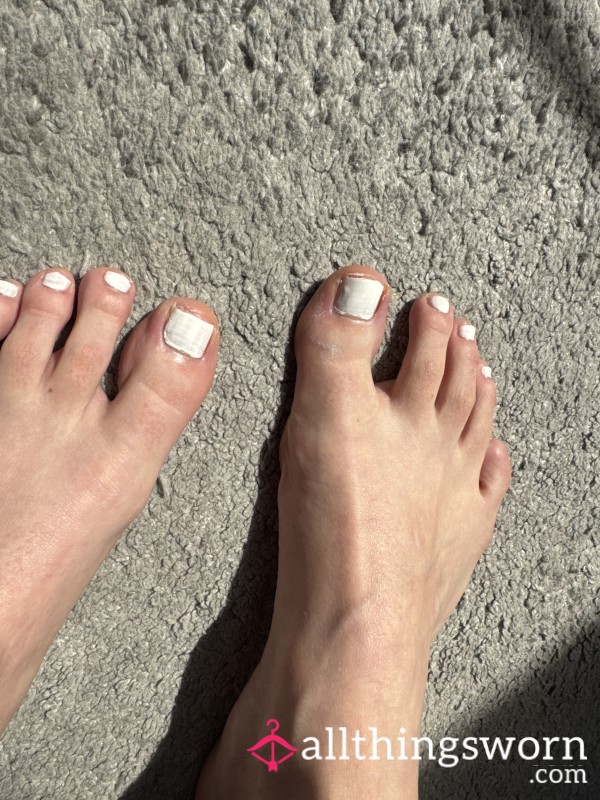 Freshly Painted White Toes On Small Feet