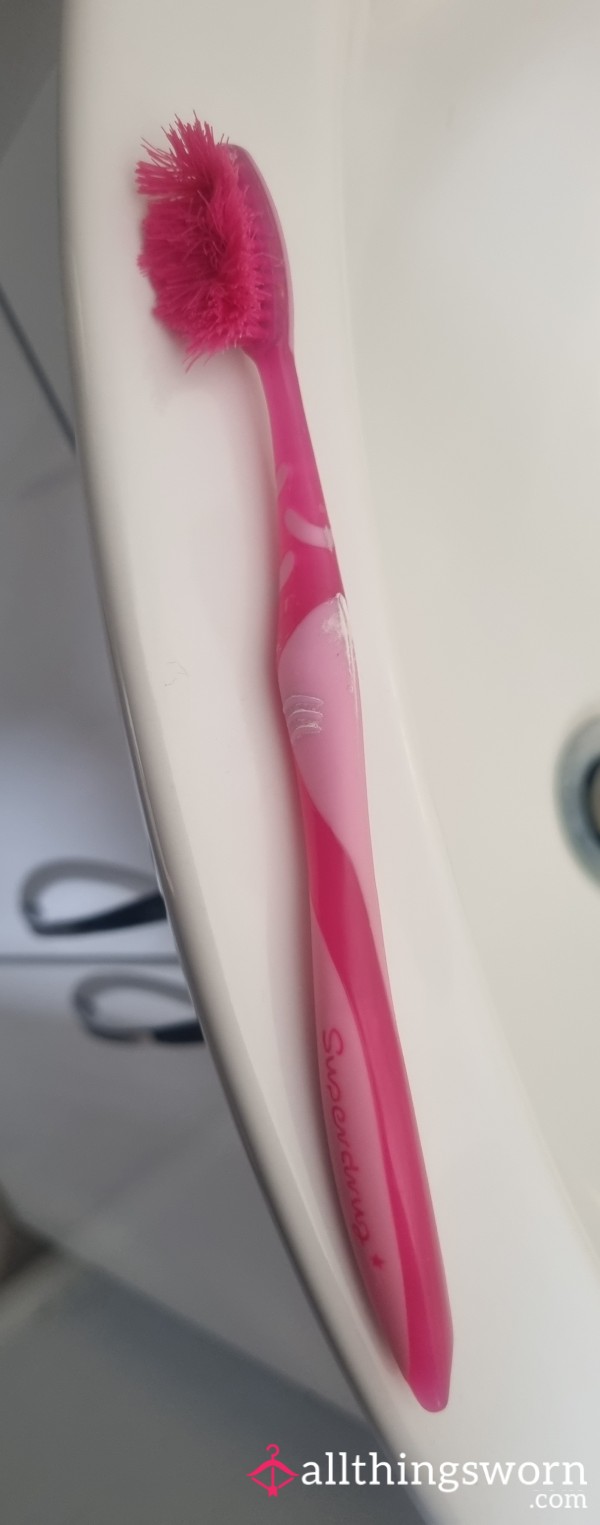 Heavily Used Pink Toothbrush