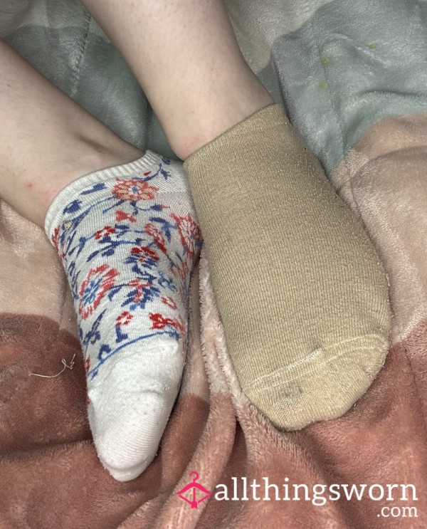 Mismatched Ankle Socks, One Beige, One White With Red And Blue Flowers And A Stained Sole