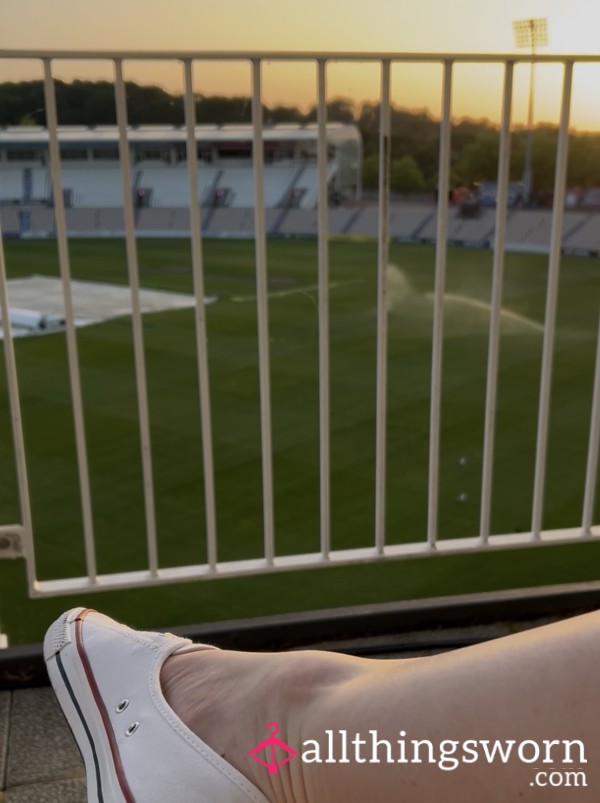 New White Converse Dangle From Balcony Overlooking Cricket Ground At Sunset