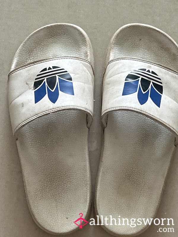 Pair Of Very Worn White Adidas Sliders