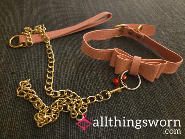 Pink Collar And Leash That Has Bow And Bell