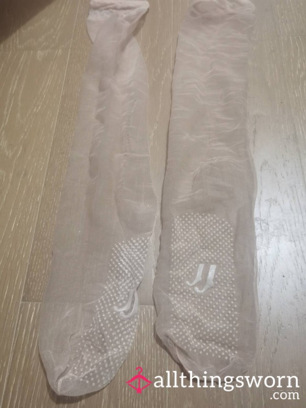 Sheer Beige Knee-Highs With A Run And Toe Hole.