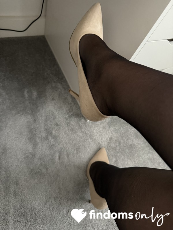 Shoe Dangling In Black Tights