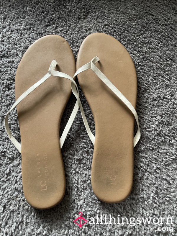 Tan And White Worn Flip Flop