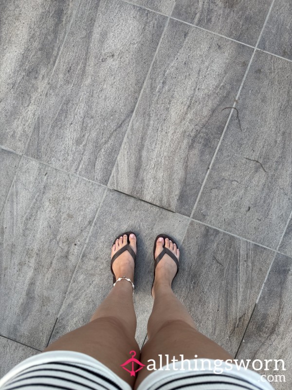 Tanned Feet And Toes In Flip Flops, Fresh Pedicure