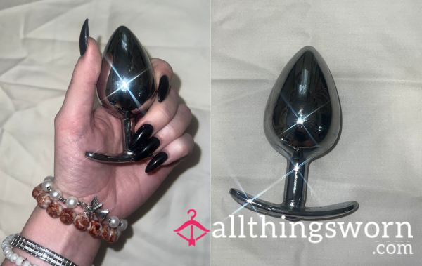 Used Large Steel Bu*t Plug With T-Flared Base And Purple Gem Stome