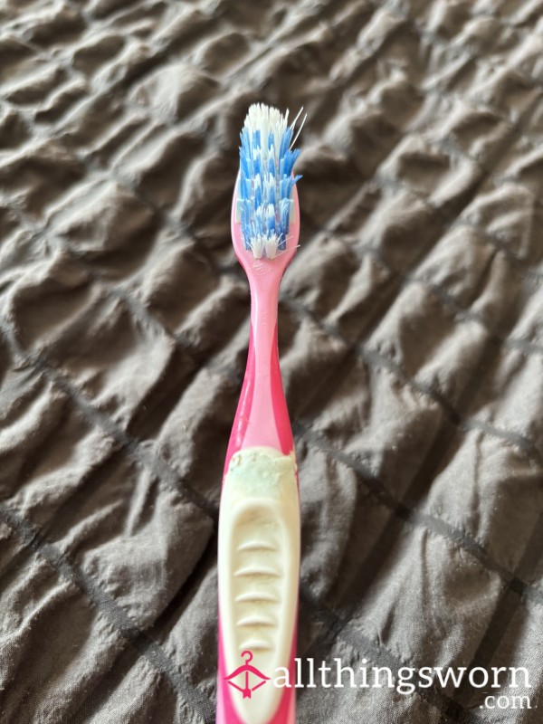 Used Pink And White Toothbrush