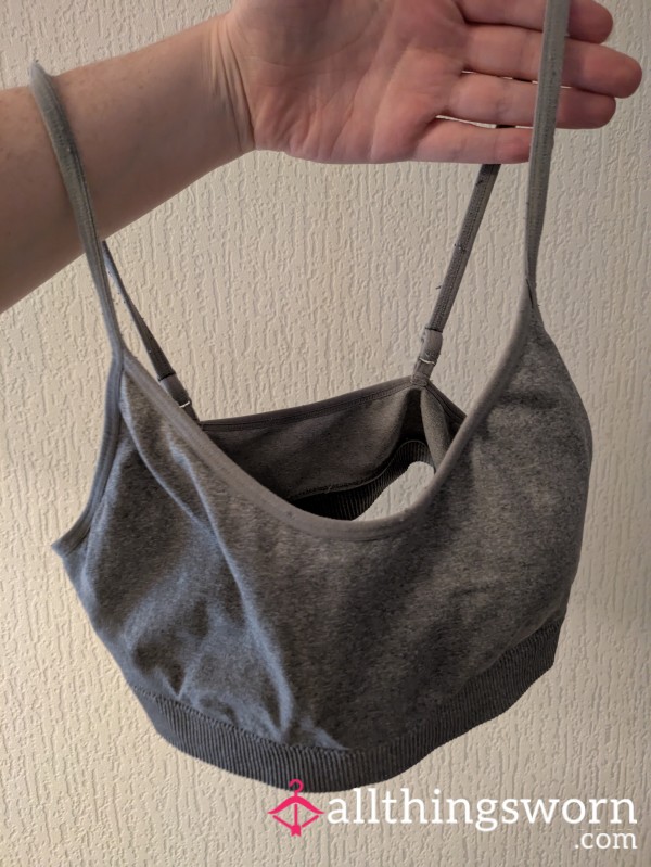 Well Worn Grey Sports Bra, Gently Faded From Use, With A Snug Fit And Soft, Broken In Fabric. Worn Continuously For 72 Hours Including Sleep, Retains Natural Scent, Offering An Authentic, Liv