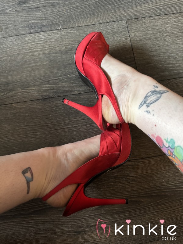Well Worn Red Satin Stilettos