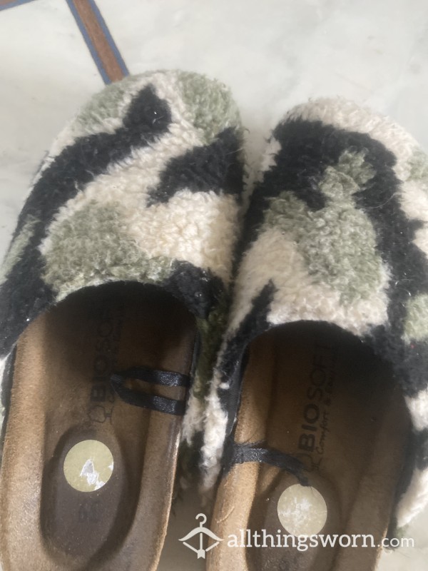 Well Worn Slippers With Feet Marks