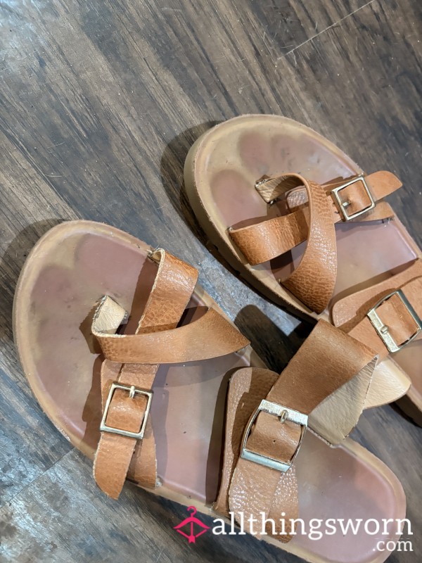 Well-worn Tan Strappy Sandals With Visible Foot Imprints, Dirt Marks, And Everyday Wear 🤎