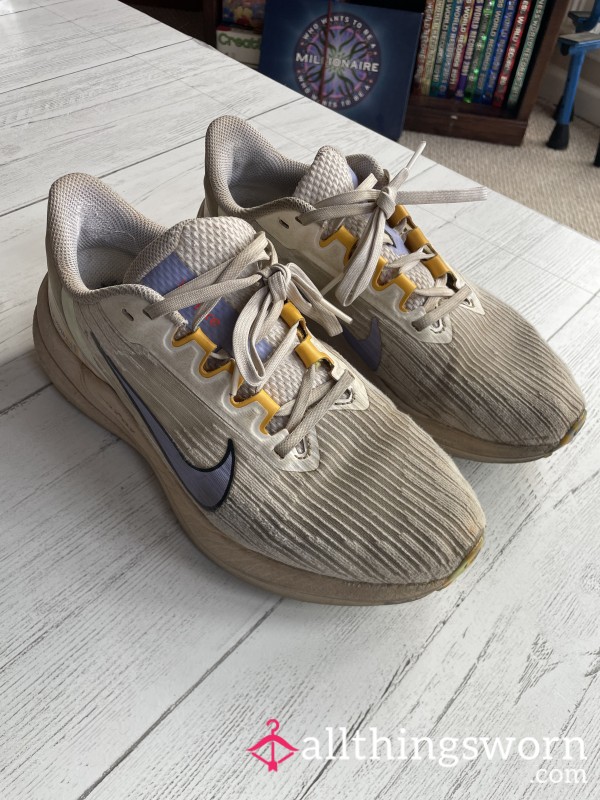 Well-worn White Nike Running Shoes