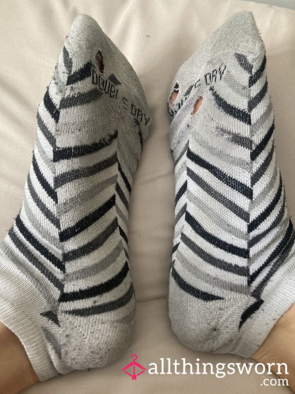 Well Worn White Socks With Holes And Black And Grey Stripes