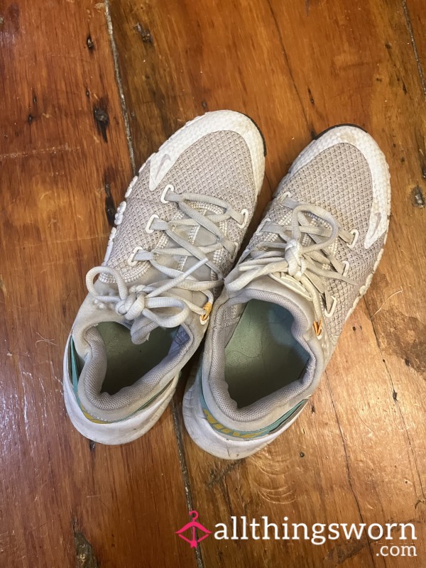Worn White Nike Running Shoes