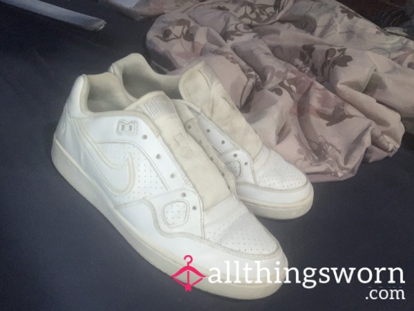 White Nikes With A Lot Of Miles On Them