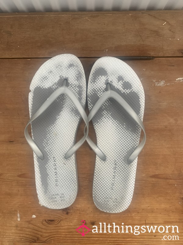 Worn Out Silver Flip Flops